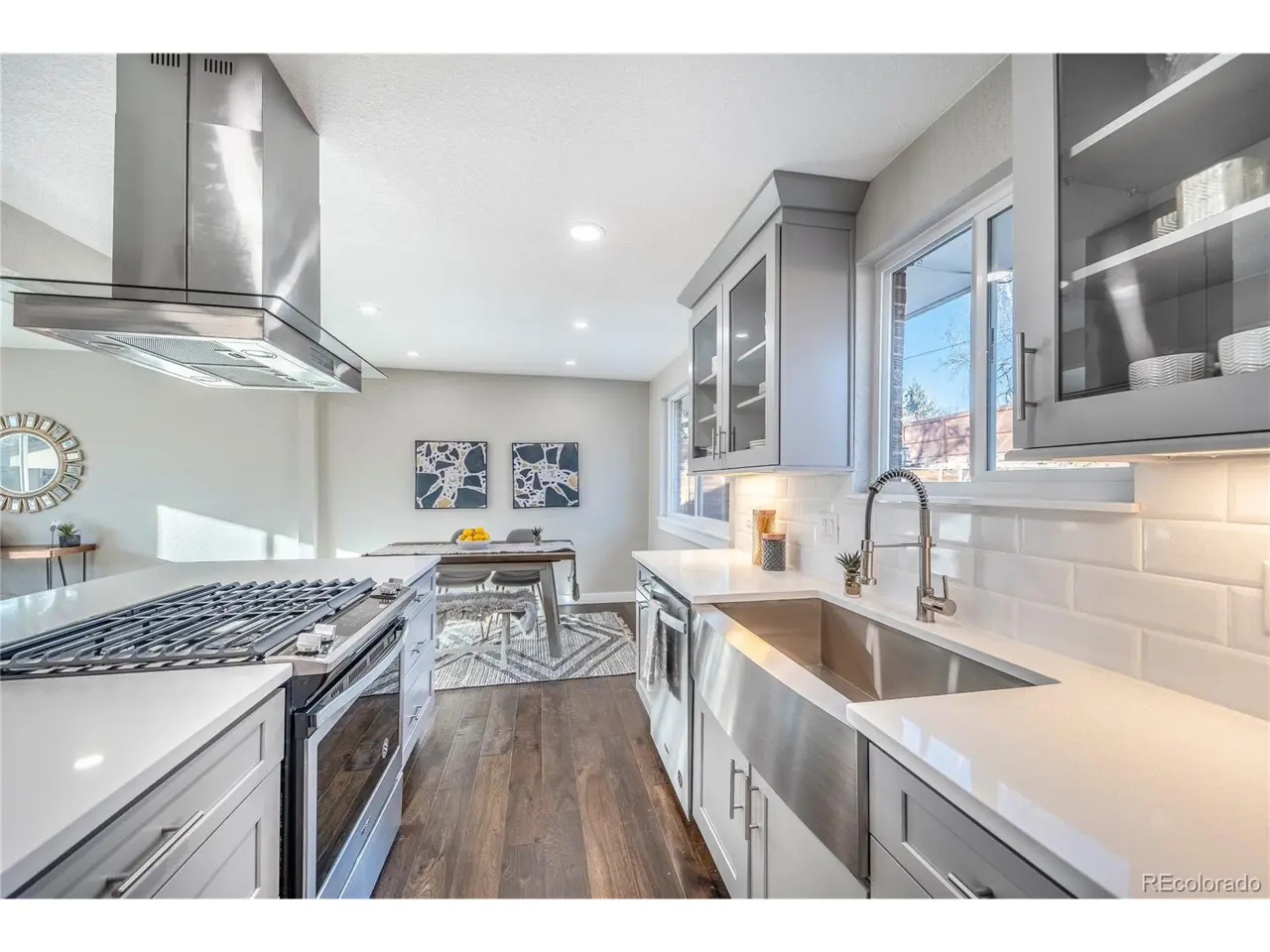 Open concept kitchen with white cabinets and large island